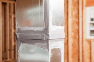 Sealed air duct in unfinished room.