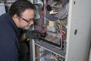 Technician working on a furnace.