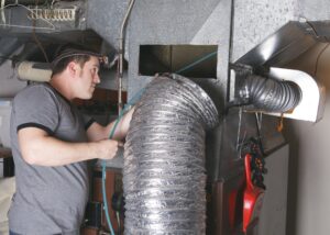 technician-fixing-ductwork